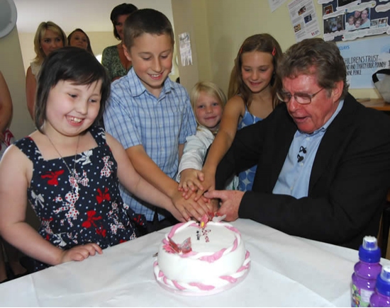 Michael Crawford and the children cut the cake! Photo