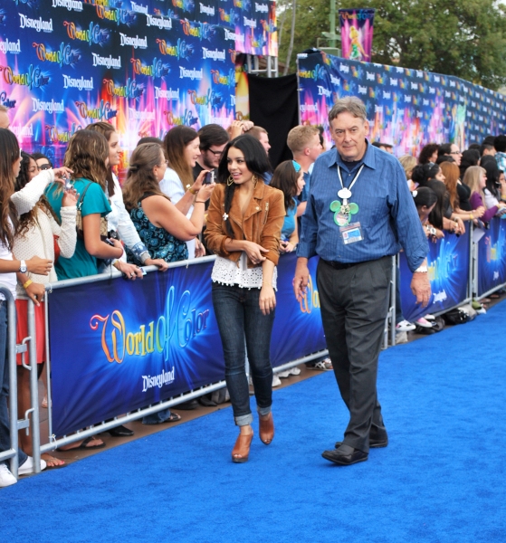 Vanessa Hudgens is escorted down the blue carpet Photo