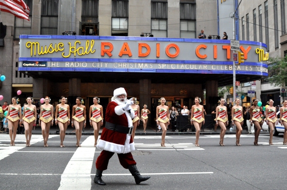 Santa Claus and the Radio City Rockettes getting ready to start the kick line Photo
