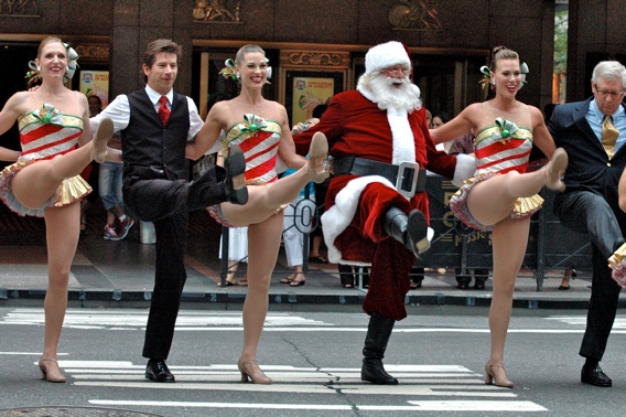 Race Taylor, Santa Claus and James Covington join in the kick line Photo