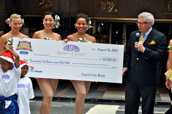 James Covington and the Radio City Rockettes present a check to the Garden of Dreams  Photo