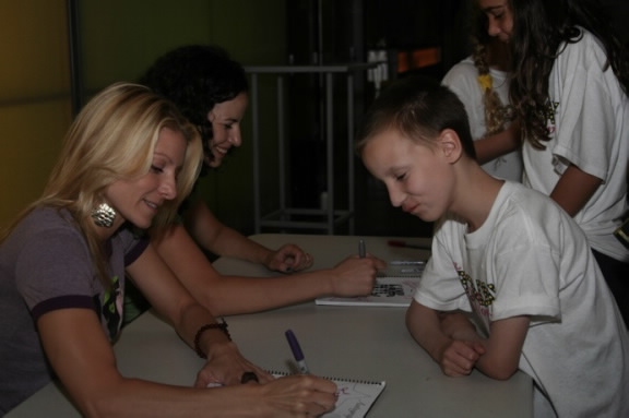 Mandy Gonzalez and Laura Woyasz sign autographs for campers  Photo