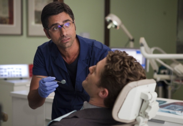 Dr. Carl (guest star John Stamos, L) checks out Will's (Matthew Morrison, R) dental h Photo