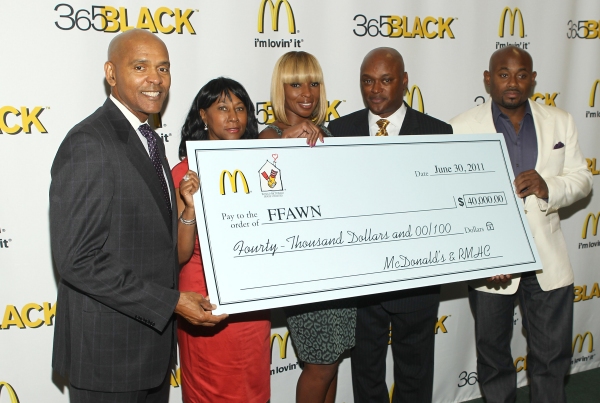 Rob Jackson, McDonald;s USA, presents a check for $40, 000 to Mary J. Blige and Steve Photo