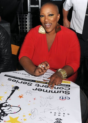 Frenchie Davis signs posters after her performance at The Grove Summer Concert Series Photo
