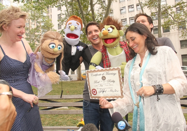 The official marriage certificate is presented to the puppets by Amy Hausman of the S Photo